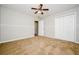 This carpeted bedroom features a closet, ceiling fan and painted wainscoting at 85 Chestnut Dr, Covington, GA 30016