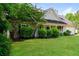Traditional home featuring a covered front porch, manicured lawn, and mature trees at 85 Chestnut Dr, Covington, GA 30016
