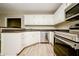 Bright kitchen featuring white cabinets, stainless steel appliances, and laminate countertops at 85 Chestnut Dr, Covington, GA 30016