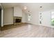 Bright living room featuring a stone fireplace, vaulted ceiling, and hardwood floors at 85 Chestnut Dr, Covington, GA 30016