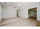 Spacious living area with wood-look floors and neutral walls, leading into the kitchen area, creating an open layout at 85 Chestnut Dr, Covington, GA 30016