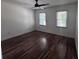 Sunlit bedroom features hardwood floors, ceiling fan, and natural light from the windows at 2000 Brickton Sta, Buford, GA 30518
