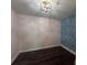 This is a spacious bedroom with blue accent wall and a modern lighting fixture at 2000 Brickton Sta, Buford, GA 30518