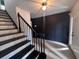 Inviting entryway with staircase and decorative wall feature and tiled flooring at 2000 Brickton Sta, Buford, GA 30518