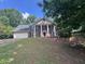 Charming two-story home with brick facade, columns, and a well-maintained front yard at 2000 Brickton Sta, Buford, GA 30518