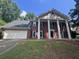 Charming two-story home with brick facade, columns, and a well-maintained front yard at 2000 Brickton Sta, Buford, GA 30518