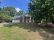 Two-story brick home with white columns, inviting entrance, and lush surrounding greenery at 2000 Brickton Sta, Buford, GA 30518