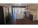 Open-concept kitchen with stainless steel appliances, an island, and hardwood floors at 2000 Brickton Sta, Buford, GA 30518