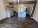 Bright kitchen view of island and dining area with stainless steel appliances and hardwood floors at 2000 Brickton Sta, Buford, GA 30518