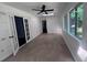 Bright living room with white walls, tile floors, and natural light streaming through French doors and windows at 2000 Brickton Sta, Buford, GA 30518