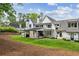 Spacious backyard showcasing the home's exterior, covered patio, and lush green lawn at 3379 Rennes Ne Dr, Brookhaven, GA 30319