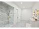 Spacious bathroom with a frameless glass shower, marble floors, and double sinks at 3379 Rennes Ne Dr, Brookhaven, GA 30319