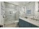 Nautical-themed bathroom with glass shower, blue vanity and sailboat wallpaper at 3379 Rennes Ne Dr, Brookhaven, GA 30319