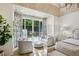 Bedroom sitting area with backyard views, hardwood floors, and stylish furniture at 3379 Rennes Ne Dr, Brookhaven, GA 30319