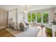 Bright bedroom with four poster bed, large windows, and hardwood floors at 3379 Rennes Ne Dr, Brookhaven, GA 30319