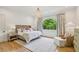 Serene bedroom with hardwood floors, chandelier, and large window with a view at 3379 Rennes Ne Dr, Brookhaven, GA 30319