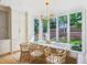 Sunlit dining area featuring white cabinetry and oversized windows with views of the backyard at 3379 Rennes Ne Dr, Brookhaven, GA 30319