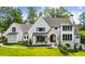 Stunning traditional home featuring a manicured lawn, light brick, and an elegant arched entryway at 3379 Rennes Ne Dr, Brookhaven, GA 30319