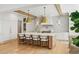 Modern kitchen with a spacious island, wooden beams, and a cozy breakfast nook filled with natural light at 3379 Rennes Ne Dr, Brookhaven, GA 30319