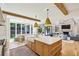 Bright kitchen with island, farmhouse sink, modern lighting, and access to outdoor living at 3379 Rennes Ne Dr, Brookhaven, GA 30319