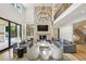 Open-concept living room featuring stone fireplace, custom built-ins, and stylish decor at 3379 Rennes Ne Dr, Brookhaven, GA 30319