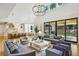 Spacious living room with high ceilings, modern furnishings, and access to the outdoor patio at 3379 Rennes Ne Dr, Brookhaven, GA 30319