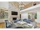 Bright living room with tall stone fireplace, custom shelving, and comfortable seating at 3379 Rennes Ne Dr, Brookhaven, GA 30319