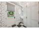Mudroom with black and white patterned tile, dog-themed wallpaper, white cabinets, and exterior access at 3379 Rennes Ne Dr, Brookhaven, GA 30319