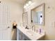 Bright bathroom featuring double sinks, a white countertop, and a large mirror at 452 Emerald Trce, Jonesboro, GA 30236