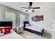 Bedroom features a ceiling fan, natural light, and contemporary decor at 452 Emerald Trce, Jonesboro, GA 30236