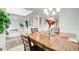 Bright dining room with view through to foyer, featuring a stylish chandelier and neutral decor at 452 Emerald Trce, Jonesboro, GA 30236