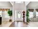 Grand foyer with high ceilings, wood flooring, and decorative plants, showcasing an open floor plan at 452 Emerald Trce, Jonesboro, GA 30236