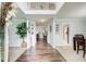 Open entryway with hardwood floors and view through to dining area, showcasing natural light at 452 Emerald Trce, Jonesboro, GA 30236