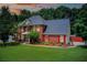 Charming two-story brick home featuring an attached garage and a beautifully landscaped front yard at sunset at 452 Emerald Trce, Jonesboro, GA 30236