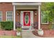 Charming front porch with red door, tasteful decor, and seating, creating a welcoming entrance at 452 Emerald Trce, Jonesboro, GA 30236