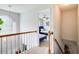 Second floor hallway with hardwood floors, a light fixture, and a view of the bedroom at 452 Emerald Trce, Jonesboro, GA 30236