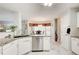 Bright kitchen featuring white cabinets, granite countertops, stainless appliances, and marble floors at 452 Emerald Trce, Jonesboro, GA 30236
