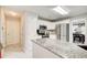 Modern kitchen with white cabinets, granite countertops, and stainless steel appliances, open floor plan at 452 Emerald Trce, Jonesboro, GA 30236
