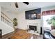 Living room features a fireplace, hardwood floors, and a large television at 452 Emerald Trce, Jonesboro, GA 30236