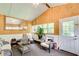 Bright sunroom with white walls, hardwood floors, and large windows overlooking backyard at 452 Emerald Trce, Jonesboro, GA 30236