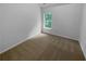 Bright bedroom features neutral carpet, fresh paint, and a window with a wooded view at 4817 Enclave Dr, Union City, GA 30291