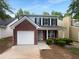 Charming two-story home with a brick facade, a garage, and lovely landscaping at 4817 Enclave Dr, Union City, GA 30291