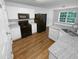 Updated kitchen with white cabinets, granite countertops, and stainless steel appliances at 4817 Enclave Dr, Union City, GA 30291