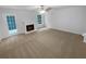 View of the living room featuring a fireplace, door, and carpeted floors at 4817 Enclave Dr, Union City, GA 30291
