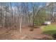 Picturesque backyard featuring lush greenery, a storage shed, and mature trees at 4150 E Chapel Hill Rd, Douglasville, GA 30135
