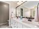 Bright bathroom with tile flooring, white cabinets, and a large vanity mirror at 4150 E Chapel Hill Rd, Douglasville, GA 30135