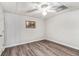 Unfurnished bedroom with laminate flooring, white walls and a ceiling fan at 4150 E Chapel Hill Rd, Douglasville, GA 30135