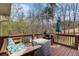 Outdoor deck featuring comfortable seating, a grill, and a serene view of the surrounding trees at 4150 E Chapel Hill Rd, Douglasville, GA 30135
