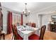 Elegant dining room with hardwood floors and formal table setting, perfect for hosting memorable meals and gatherings at 4150 E Chapel Hill Rd, Douglasville, GA 30135