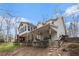 Spacious home exterior showcasing a large covered patio, sunroom and well-maintained landscaping at 4150 E Chapel Hill Rd, Douglasville, GA 30135